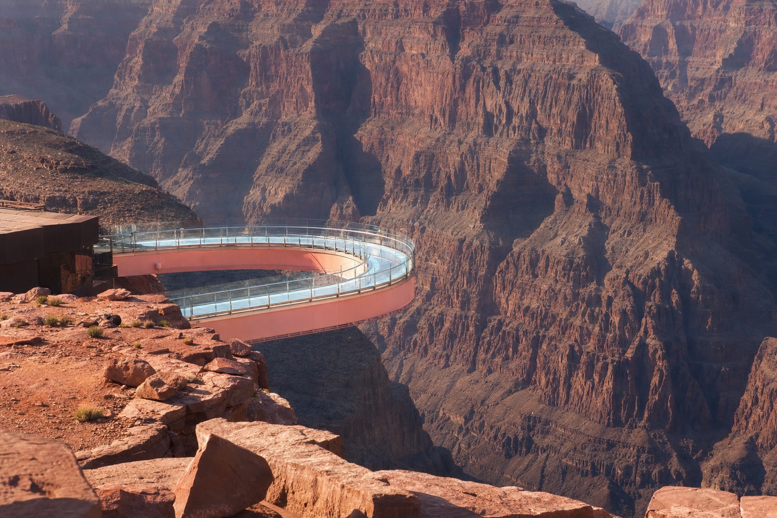 The horseshoe-shaped glass Skywalk bridge extending over the Grand Canyon at Grand Canyon West in late afternoon light