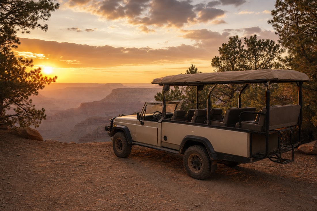 An open-sided safari vehicle parked near a South Rim overlook as the canyon turns orange at sunset