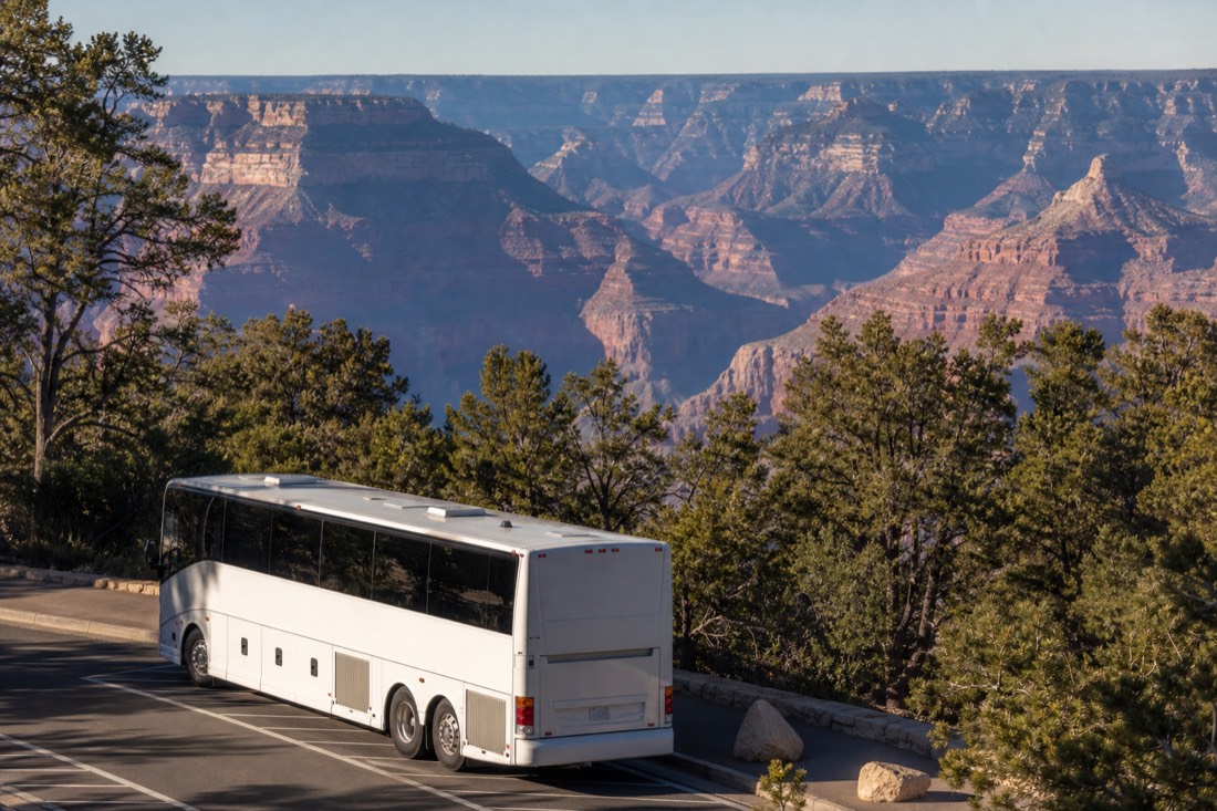 A tour bus parked at a South Rim viewpoint with the canyon stretching out behind it