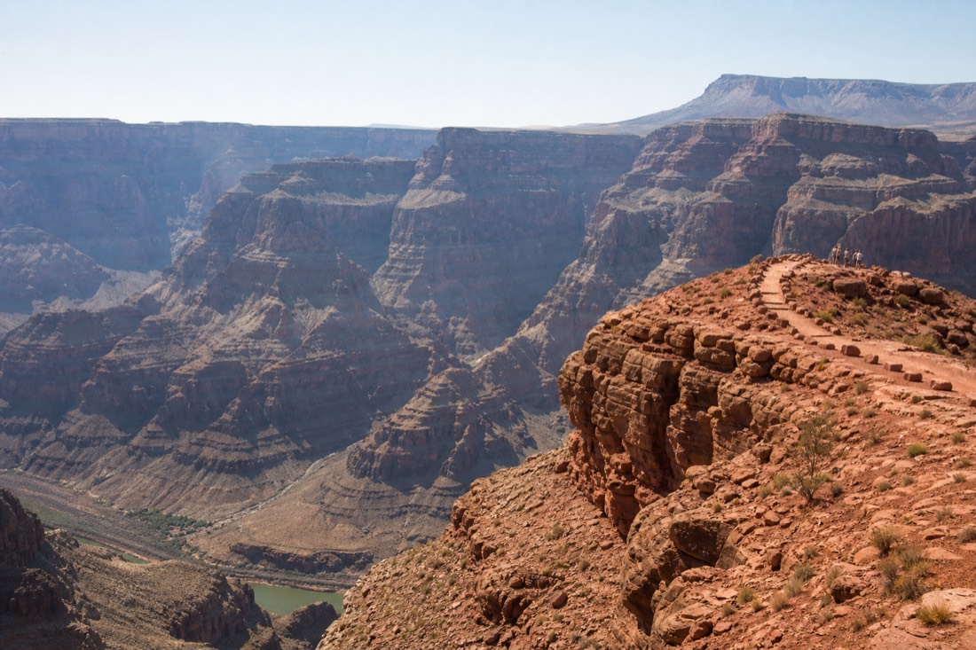 Visitors at the Guano Point overlook at Grand Canyon West with the Colorado River bending far below