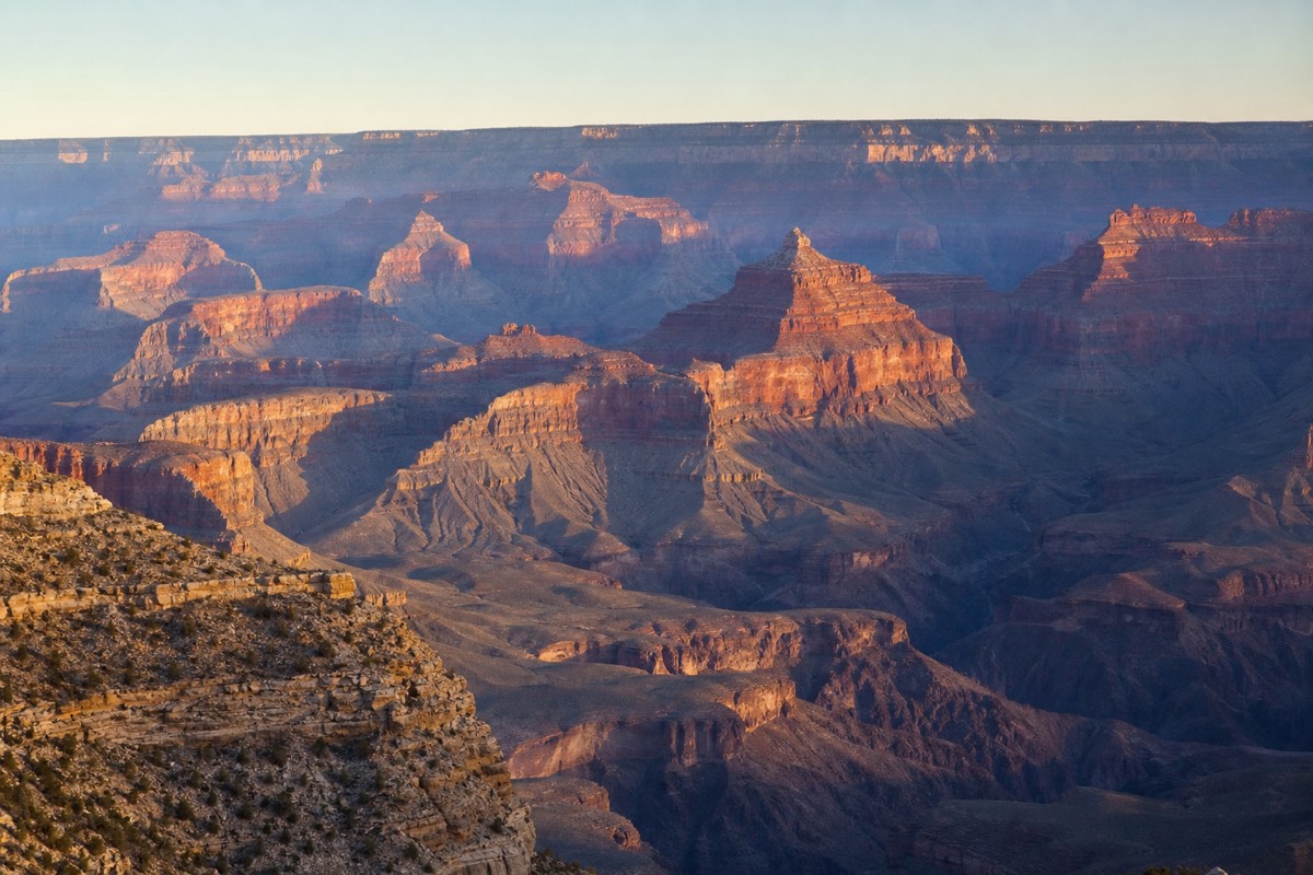 The classic South Rim panorama from Mather Point with layered temples and buttes in warm evening light