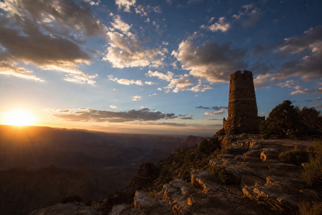 The Desert View Watchtower silhouetted at the eastern entrance of Grand Canyon National Park under a big sky