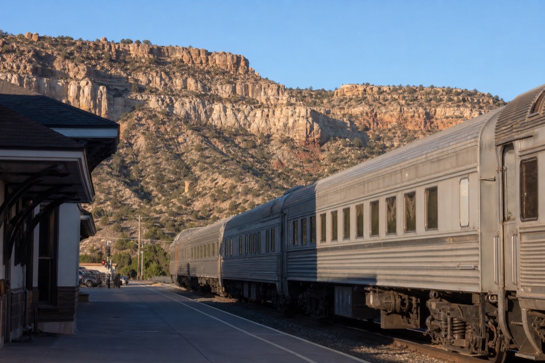 A vintage passenger train waiting at the Williams depot on a clear Arizona morning